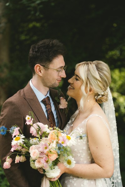 Bride and groom look at each other smiling