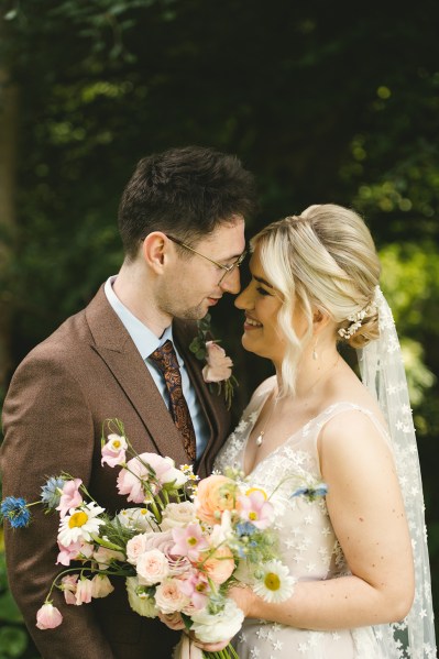 Bride and groom look at each other smiling