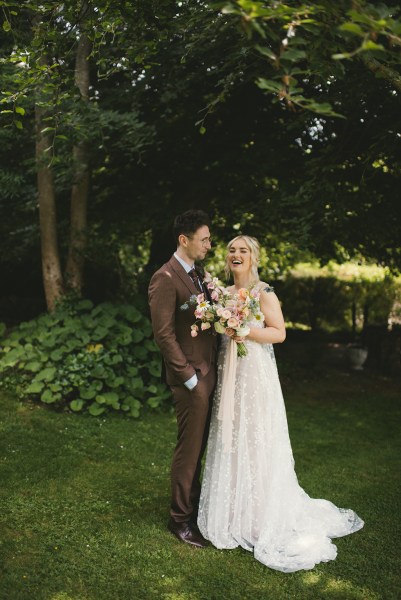 Bride and groom smile and look at each other