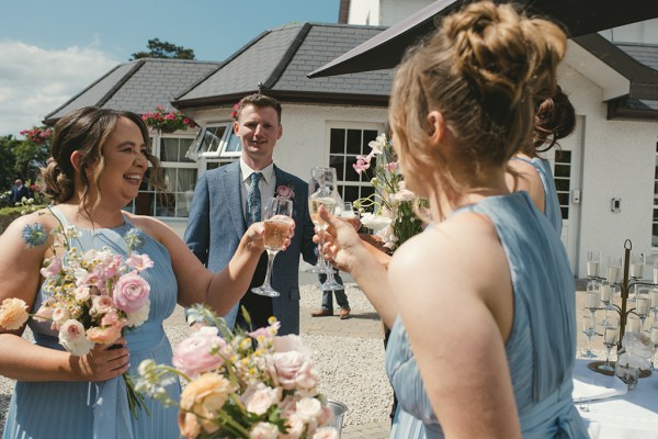 Bridesmaids cheers with glasses of champagne/prosecco