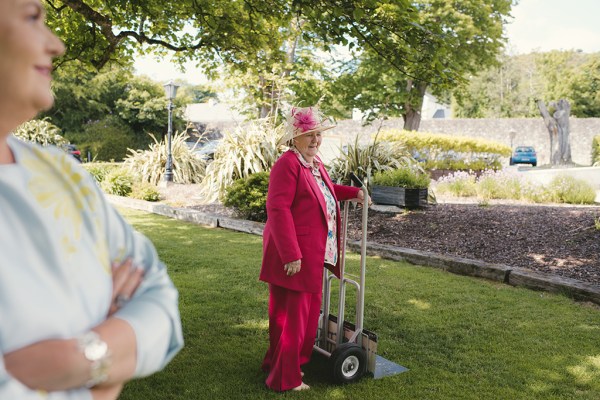 Woman in pink suit smiles