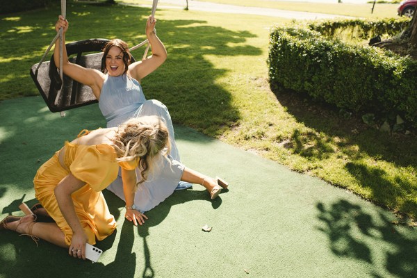 Two women and a swing grass setting