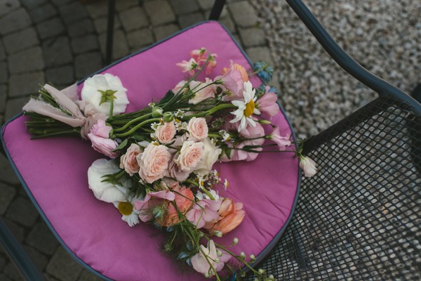 Pink flowers resting on pavement