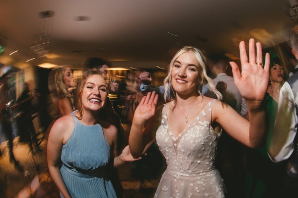 Bride dances on the dancefloor with mate friend