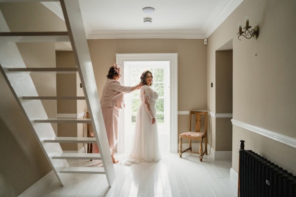 Bride and mother at the end of staircase