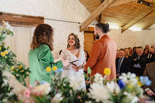 Celebrant bride and groom at alter smiling