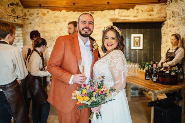 Bride and groom pose happily for the camera all smiles