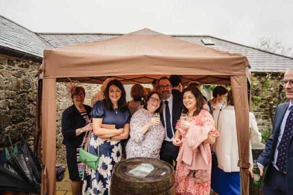 Guests smile for the camera under tent