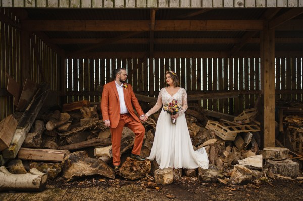 Bride and groom exterior in garden forest leaves bouquet in hand