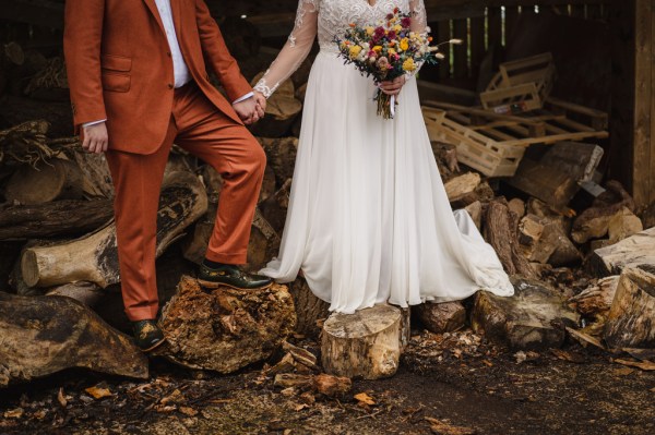 Bride and groom exterior in garden forest leaves bouquet in hand