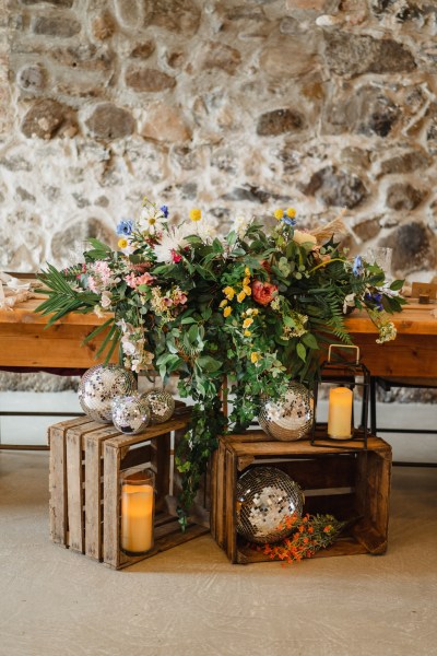 Interior table ballroom setting decor wooden candles lit and flowers in shot