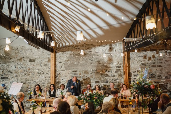 Father gives speech to guests microphone in hand