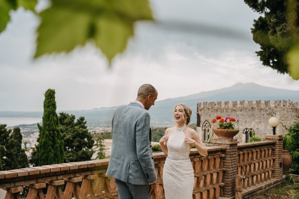 bride and groom at top of wedding venue balcony