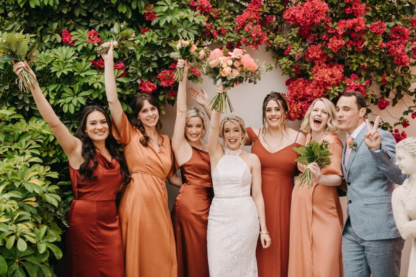 bride bridesmaids bridal white gown autumnal dresses colour and bouquets in the air