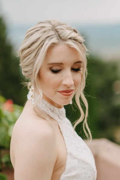 bride looks down as she poses in garden