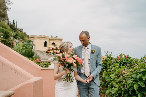 bride and groom at top of steps landscape in background