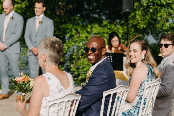 man smiles towards the camera during ceremony setting