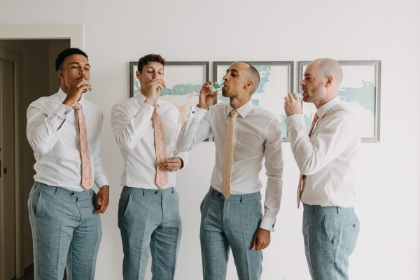 groom and groomsmen take a drink / shot