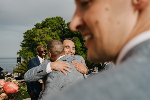 groom hugs groomsmen