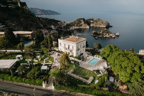 drone shot view of wedding venue swimming pool ocean mountains and landscape