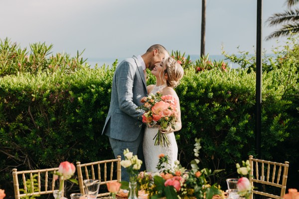 bride and groom kiss at the dining room table