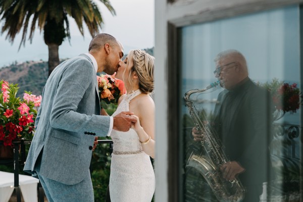 Bride and groom kiss reflection