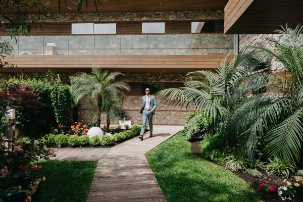 groom makes his way through the garden