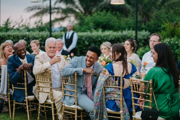 guests at dining room table looking at speeches take place