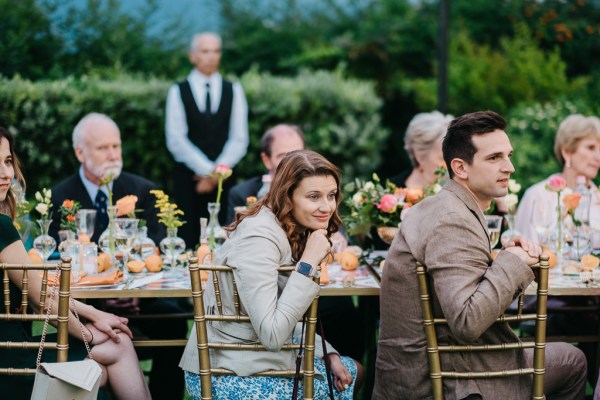 guests at dining room table looking at speeches take place