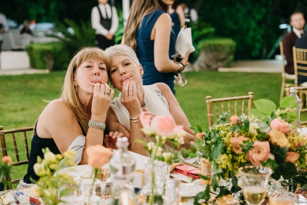 two women at the dining room table pose