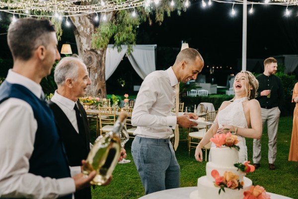 bride groom cutting the white wedding cake