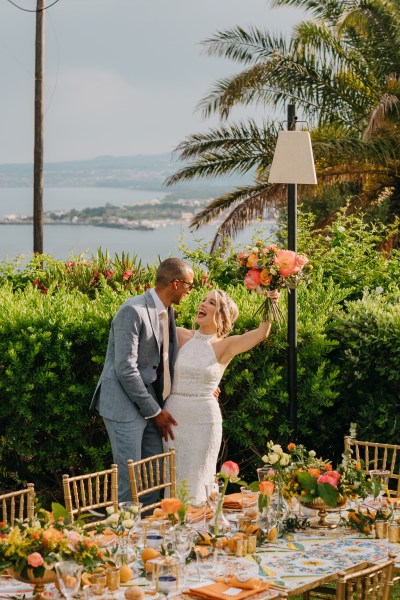 bride and groom smile celebrate bouquet in the air