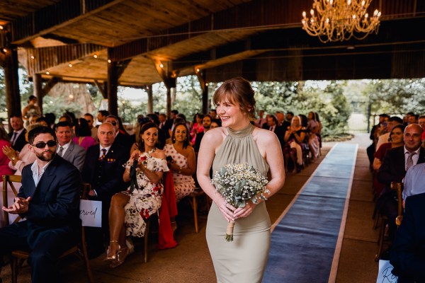 Bridesmaid walks down the aisle