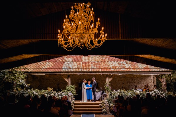 Chandelier in view bride groom and celebrant at alter