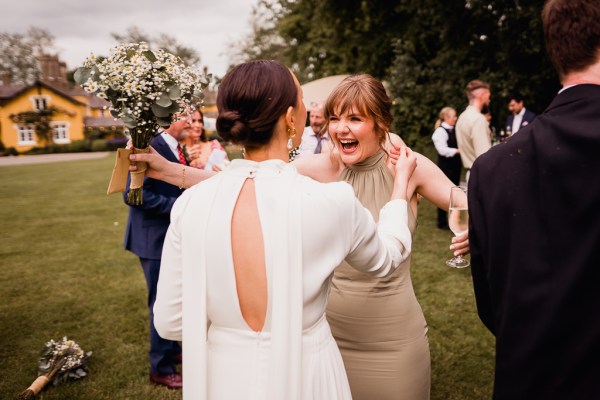 Bride hugs female guest