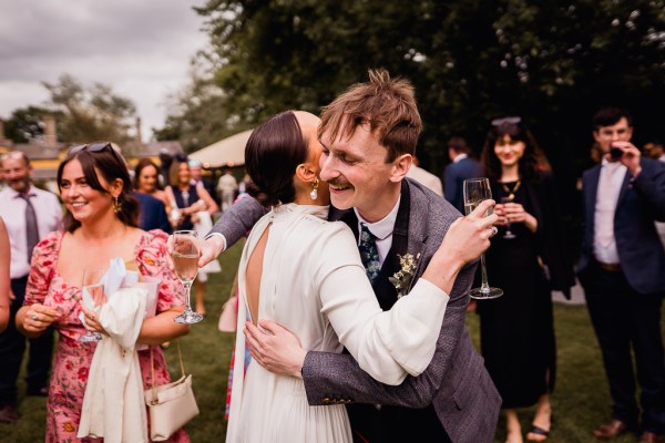 Bride hugs male guest