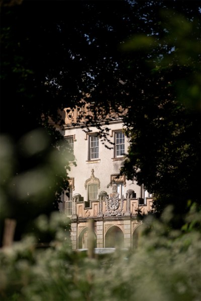 View through trees of wedding venue