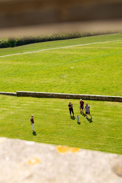 Guests playing sport outside on the grass