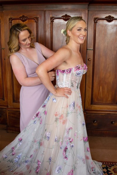 Bridesmaid helps bride get ready