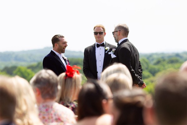 Groom and groomsmen await the bride at the alter