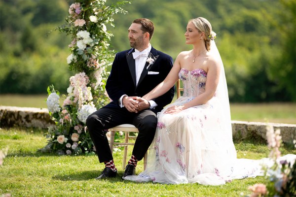 Bride and groom seated during ceremony