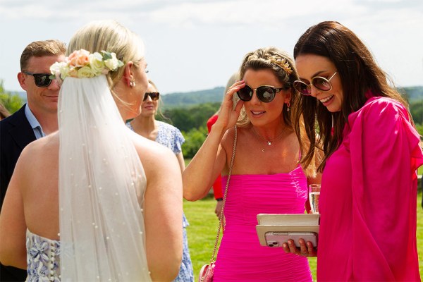 Friends admire brides bridal gown