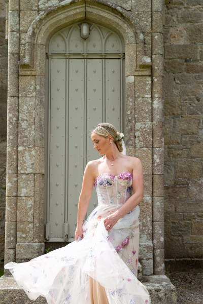 Bride swings dress around shows off bridal gown smiling