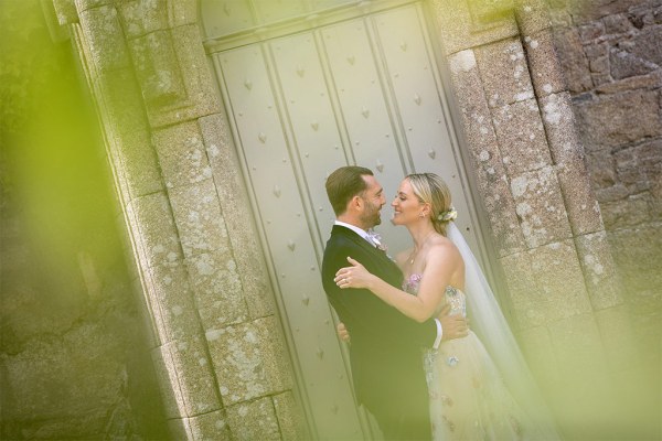 Grass view of bride and groom kissing