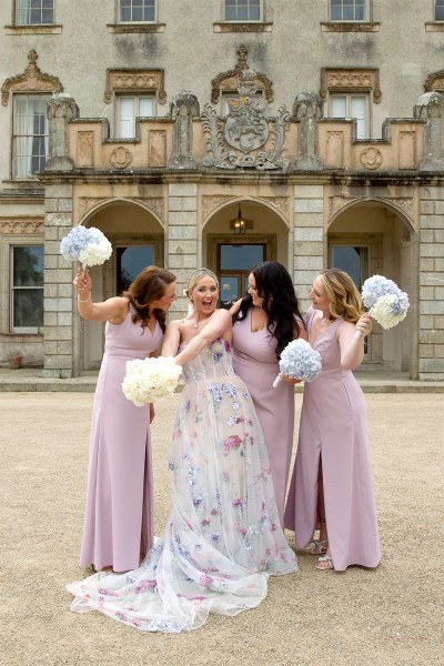 Bride and her bridesmaids with bouquets in the air