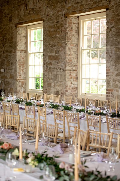 Empty dining room interior ballroom for guests candles and glasses on tables window view bottle of red wine