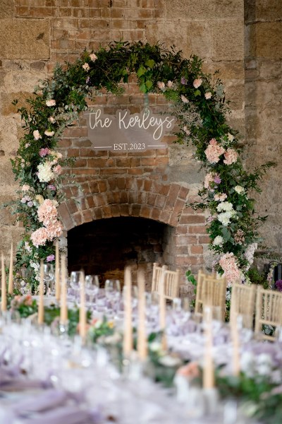 Empty dining room interior ballroom for guests candles and glasses on tables window view bottle of red wine flower bed