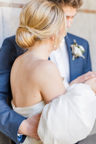 Bride and groom hair detail from behind arms around waist