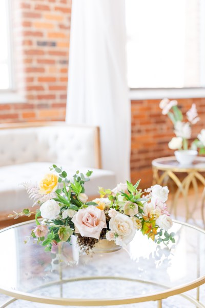 Chair in background and flowers pink roses in foreground