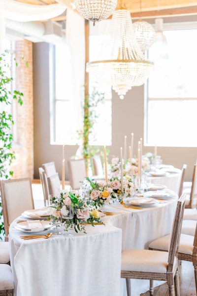 Empty dining room table setting flowers chairs and curtain in view